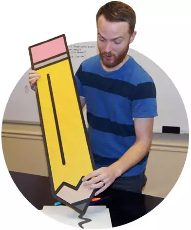 man with a giant pencil